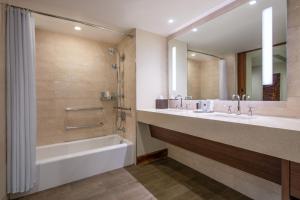 a bathroom with a tub and two sinks and a bath tub at JW Marriott Marco Island Beach Resort in Marco Island