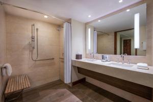 a bathroom with two sinks and a large mirror at JW Marriott Marco Island Beach Resort in Marco Island