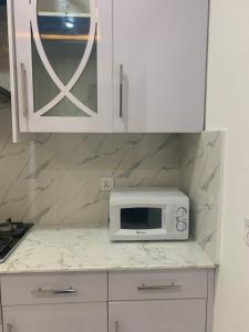 a microwave oven sitting on a counter in a kitchen at Bahria Residency 1 in Islamabad