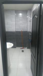 a bathroom with a shower and a sink and a toilet at Immeuble Thala in Tigzirt