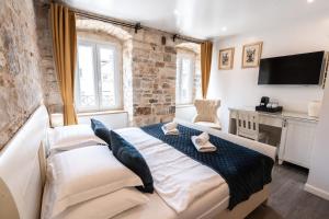a bedroom with a large bed and a desk at Luxury Rooms Lucija and Luka in Split
