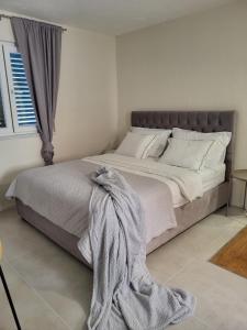 a bedroom with a large bed with a blanket on it at Old Town Sedlar Apartment in Split