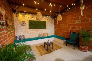 a patio with a bench and a chair and a brick wall at Spring Hostel in Medellín
