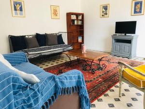 a living room with a couch and a table at Gîte de la Perdrix 