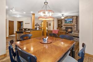 a dining room and kitchen with a wooden table and chairs at Bearfoot Lodge in Banner Elk
