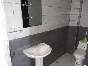 een badkamer met een wastafel en een toilet bij Immeuble THALA in Tigzirt
