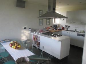 a kitchen with a bowl of fruit on a table at B&b La corte dei Gelsomini in Ponteranica +29 photos