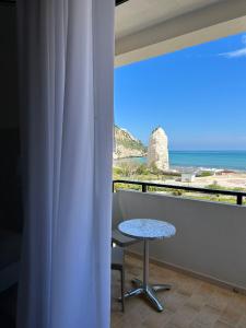 a balcony with a table and a view of the ocean at Bikini Hotel in Vieste