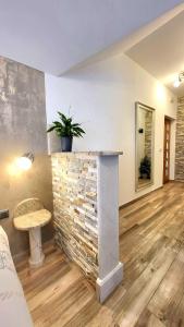 a living room with a stone fireplace and a table at Korčula Old Town MARIJA Apartment in Korčula