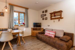 a living room with a couch and a table at Piekvier lodge in Schladming