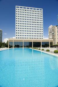a large blue and white swimming pool in front of a building at The Marmara Antalya in Antalya