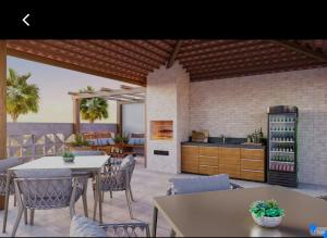 a kitchen and dining room with tables and chairs at Apartamento á 300 metros da praia de Itaparica e efrente o shoping bullevard in Vila Velha