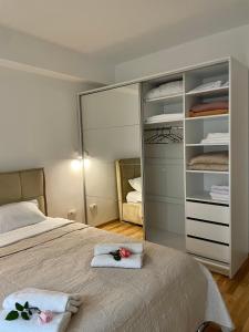a bedroom with a bed with two towels on it at Golden Apartment in Skopje
