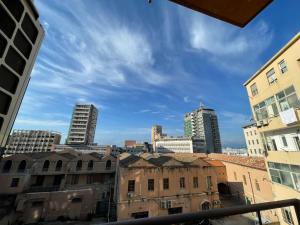 a view of a city from a window with buildings at Casa Obìa in Cagliari