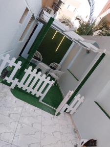 a white fence on a yard with a table and chairs at استوديو in 6th Of October