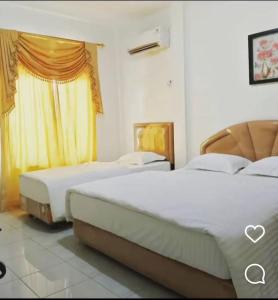 Tempat tidur dalam kamar di Flamboyan House