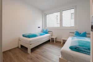 a bedroom with two beds and a window at Apartment Eflin in Fulpmes