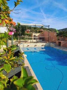 a large swimming pool with blue water at Bandol studio dans villa proximité mer avec piscine in Bandol