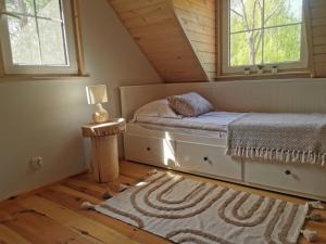 a small bedroom with a bed and a window at Domek na Skarpie in Miłomłyn