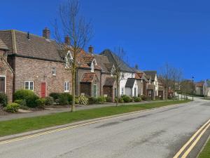 a row of brick houses on a street at Dragonfly Cottage in Filey