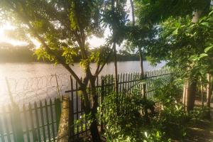 a fence next to a body of water at Pousada Vista do Rio in Barreirinhas