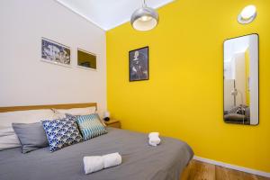 A bed or beds in a room at Stylish yellow suite in the heart of Budapest