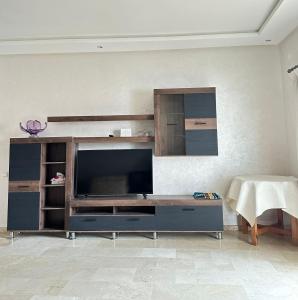 a living room with a large entertainment center with a flat screen tv at Nice Apartment in Marina Agadir in Agadir