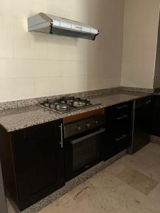 a kitchen with a stove and a counter top at Nice Apartment in Marina Agadir in Agadir