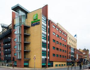 a building with a sign on the side of it at Holiday Inn Express - Glasgow - City Ctr Riverside, an IHG Hotel in Glasgow