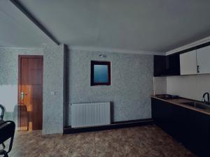 a kitchen with a sink and a counter top at Cottage Kesane in Kazbegi