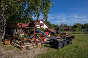 a playground in a yard next to a house at DOMKI LUNA in Rowy