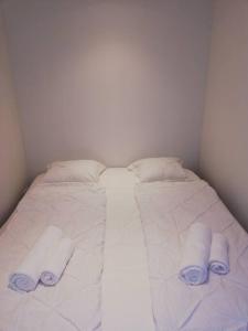 a white bed with three pillows on top of it at Urlaub in Alberschwende in Alberschwende