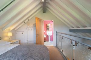 a attic room with a bed and a door at The Buttery in Freston