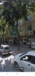 a white car parked on a street in front of a building at M&G centar grada in Požarevac