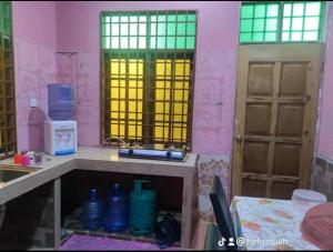 Kampong Kubang GolokTokMaa Inap Desa的带水槽的厨房和2扇窗户