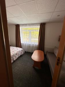 A bed or beds in a room at Penzión Michaela Vyhne