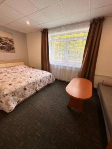 A bed or beds in a room at Penzión Michaela Vyhne