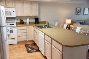 a kitchen with a sink and a counter top at Sandcastle 6G - Dauphin Island Real Estate in Dauphin Island
