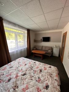 A bed or beds in a room at Penzión Michaela Vyhne