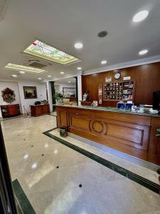 a large lobby with a counter in a store at Hotel Principe Di Piemonte in Rome