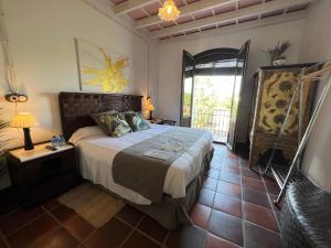 a bedroom with a large bed and a window at ON Acebuchal 23 in El Rocío