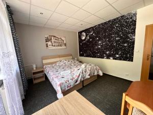 A bed or beds in a room at Penzión Michaela Vyhne