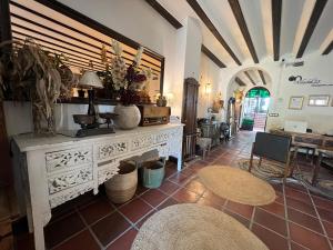 a living room with a white table and a room with a table at ON Acebuchal 23 in El Rocío