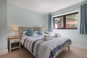 a bedroom with a bed with two teddy bears on it at The Kelling in Blakeney