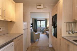 a kitchen with a living room and a dining room at Burnham A in Blakeney