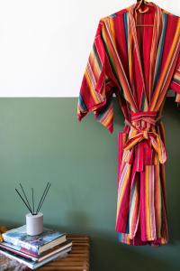 a colorful robe hanging on a wall next to a table at Mellow Moon Lodge in Del Norte