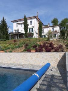 a house with a swimming pool in front of a house at Villa Pavone in Coreglia Antelminelli