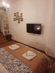 a living room with two napkins and a flat screen tv at Old Town Rab Studio apartment in Rab