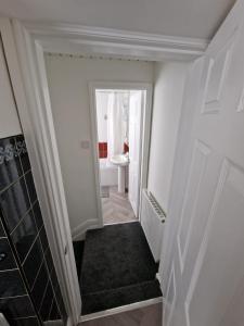 a hallway with a staircase leading to a bathroom at Luna Apartments Newcastle Gateshead 1 in Gateshead