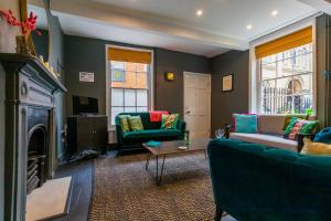 a living room with two couches and a fireplace at Princes Cottage in Norwich